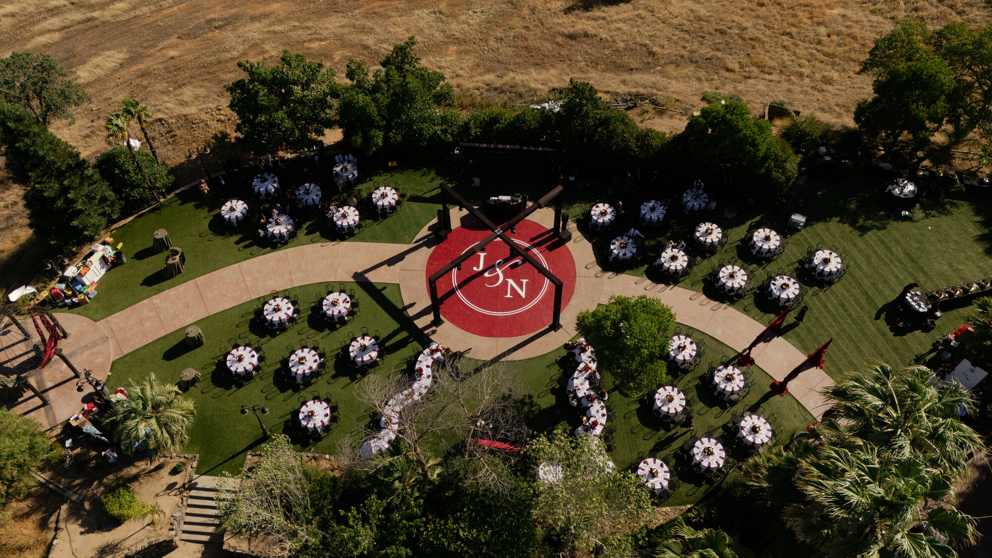 An aerial view of a ceremony and reception laid out across the estate lawn
