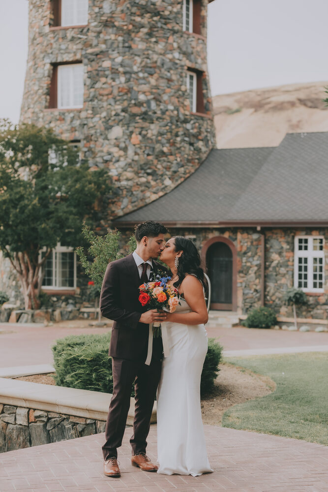 A couple sharing a kiss outside the Castle