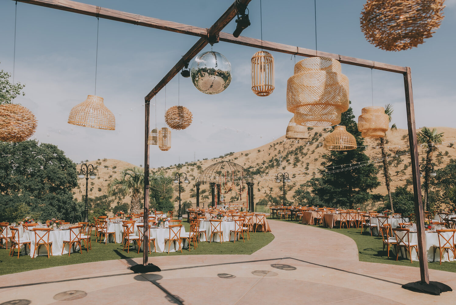 A reception glowing under hanging lanterns at dusk