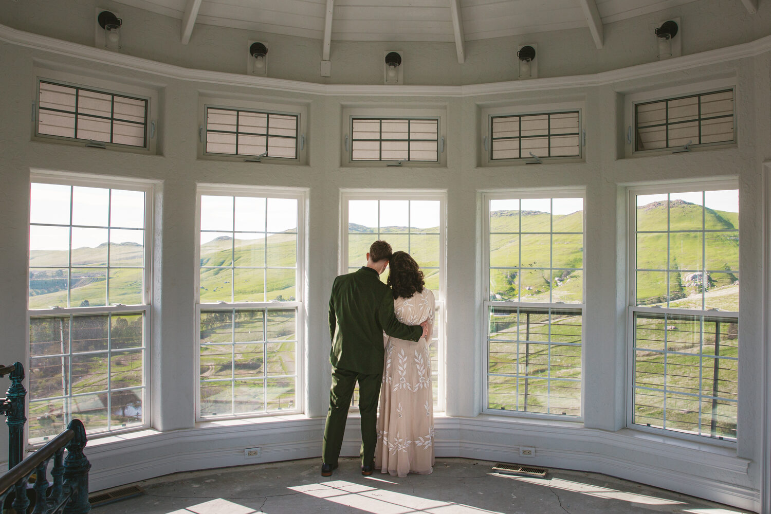 A couple embracing in the light of the Rotunda windows