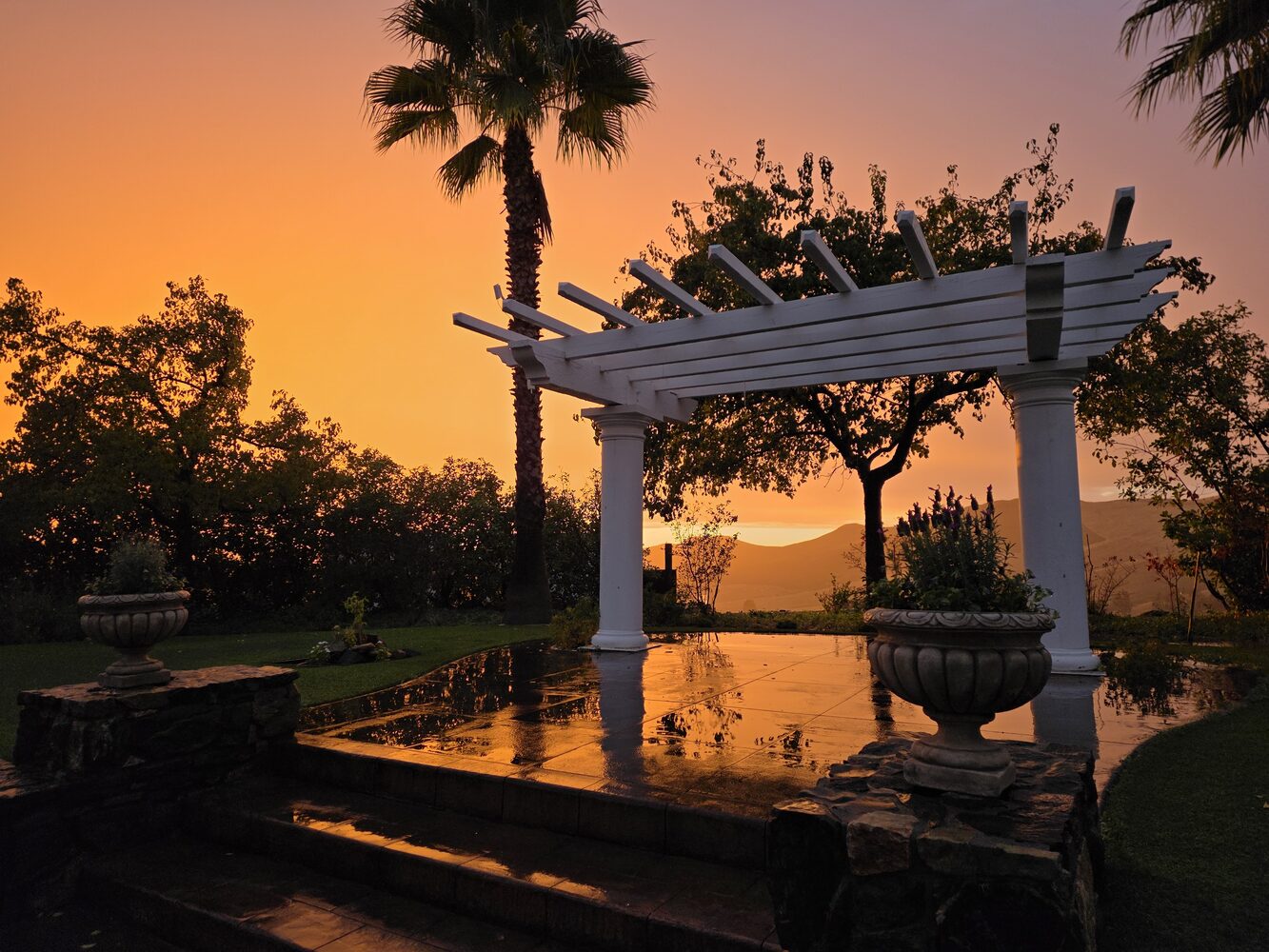 The garden pergola against a burning foothill sunset