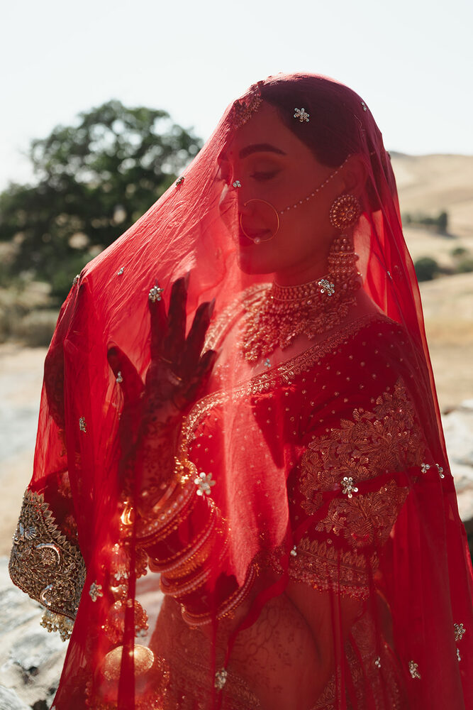 A bride in a richly embroidered red veil