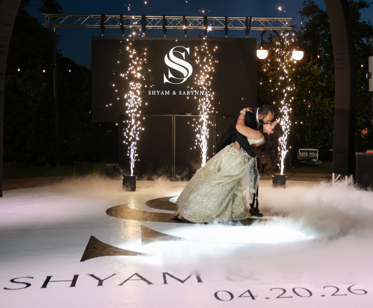 A couple's first dance amid sparklers and haze