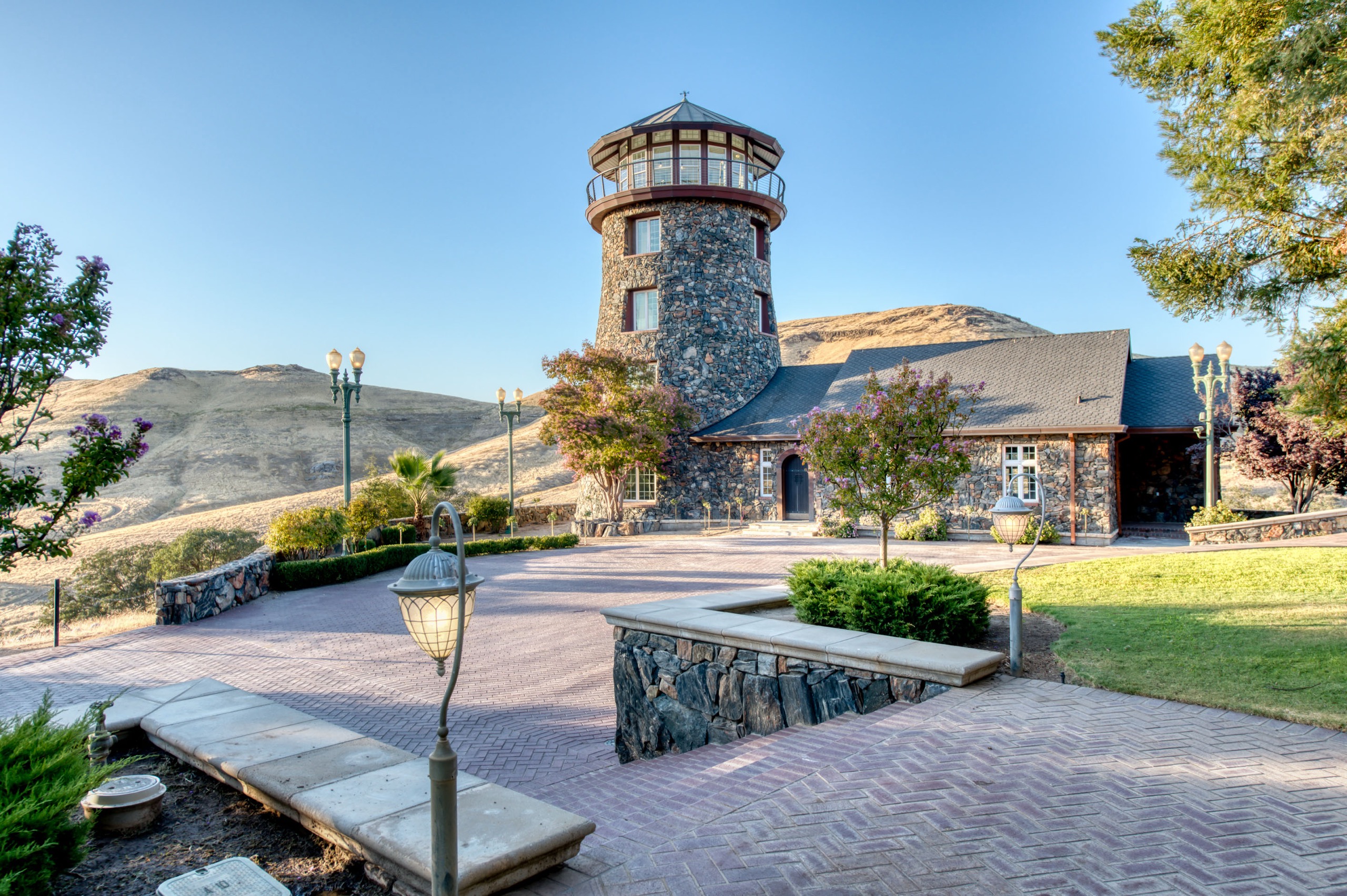 The Tower Courtyard at golden hour, the lighthouse rising behind