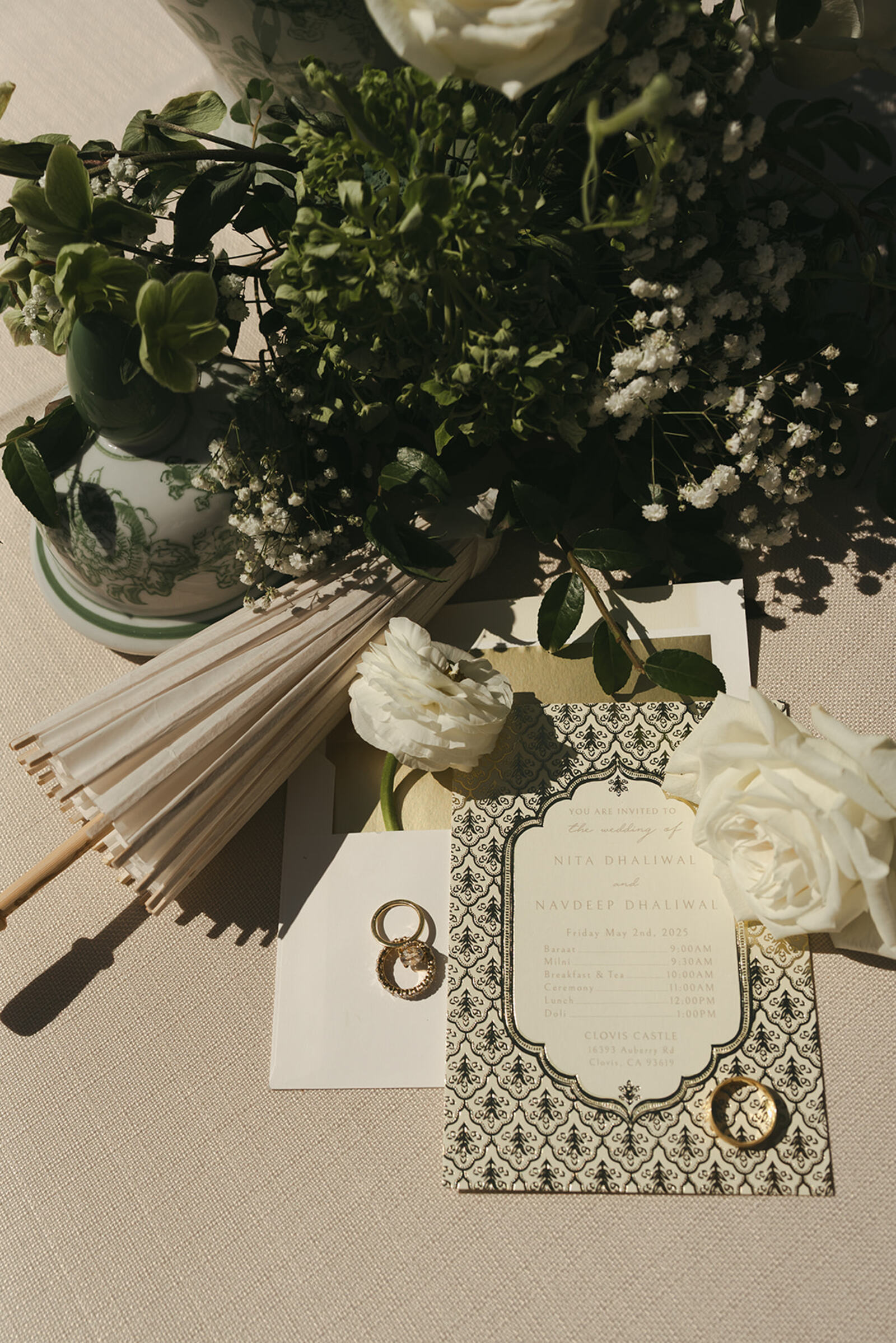 Wedding stationery and styling details — an invitation with fans and white roses