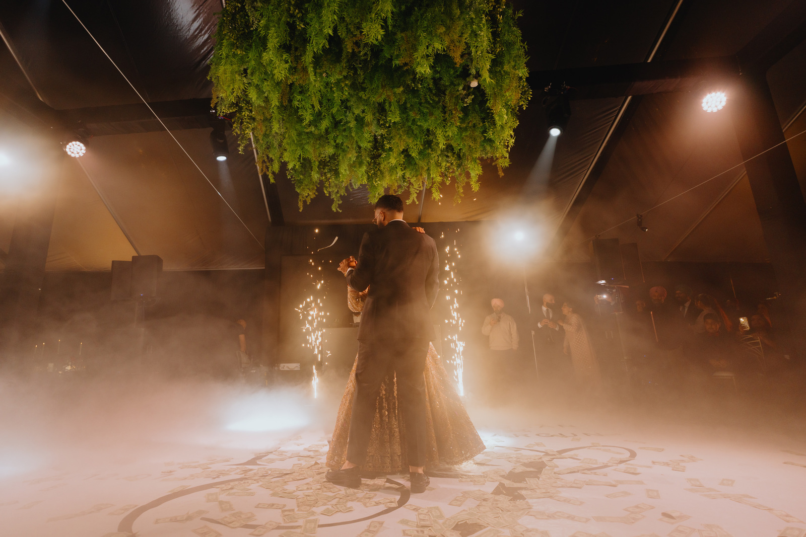 A couple's first dance under sparklers and haze